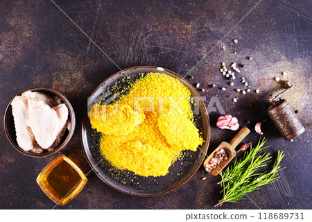 chicken wings with panko in a gray ceramic bowl on a rustic table ready to cooking chicken wings with panko in a gray ceramic bowl on a rustic table ready to cooking 118689731