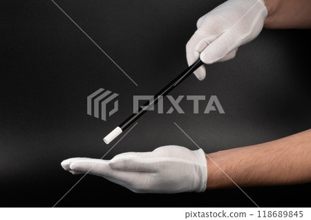 Hands in white glove with magical stick 118689845