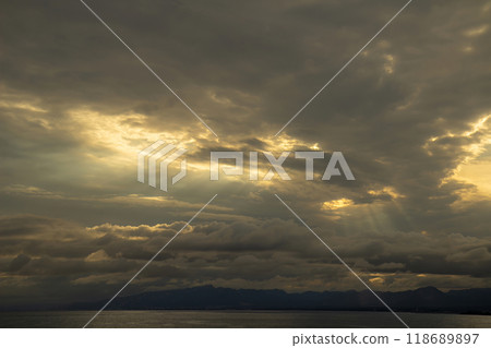 Dramatic sunset sky with evening sky clouds lit by bright sunlight 118689897