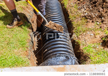 During construction, black drainage pipes are installed in trenches During construction, black drainage pipes are installed in trenches 118690081