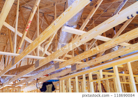 Installing silver insulation ventilation HVAC pipes during construction 118690084