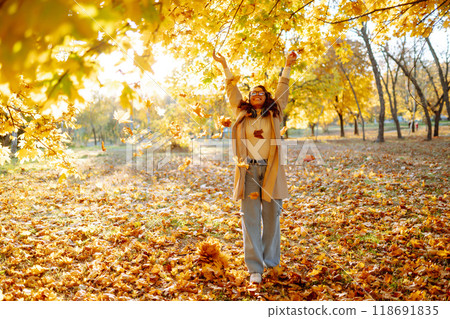 Beautiful woman taking pictures in the autumn forest. Rest, relaxation, tourism, lifestyle concept. 118691835