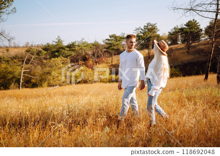 Young couple having fun walking and hugging n the park. Autumn weather. Relaxation, youth. 118692048