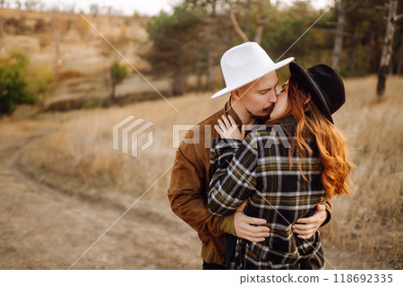 Lovely hipster couple enjoying each other in the autumn park. Nice autumn day. love and lifestyle. Lovely hipster couple enjoying each other in the autumn park. Nice autumn day. love and lifestyle. 118692335