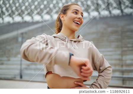 Sports woman in sportswear does exercises outdoors. . Sport, active lifestyle, healthy lifestyle concept. Sports woman in sportswear does exercises outdoors. . Sport, active lifestyle, healthy lifestyle concept. 118692611