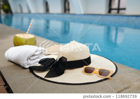 Enjoying Relaxation by Poolside with Straw Hat 118692739