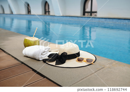 Relaxing by Swimming Pool with Refreshment Drink 118692744