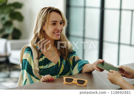 Smiling Woman Receiving Object at Reception Desk Smiling Woman Receiving Object at Reception Desk 118692881