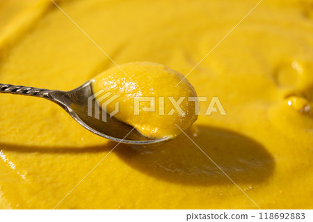 Traditional spicy mustard sauce in a spoon close-up. 118692883