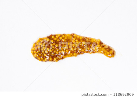 Smear of French Dijon mustard on a white background, top view Smear of French Dijon mustard on a white background, top view 118692909