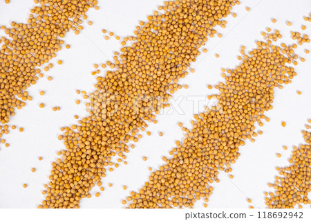 Scattered Dry Yellow Mustard Grains on White Background Top View 118692942