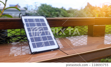 Close up small solar panel designed to power decorative lights along a balcony. The image highlights the compact solar cells, showcasing their functionality eco-friendly energy use. 118693755
