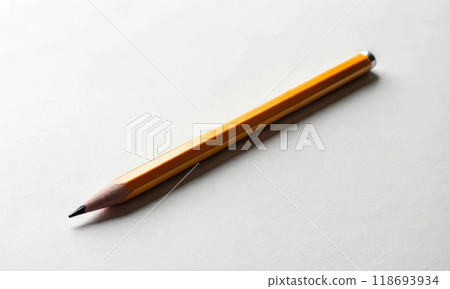A simple wooden pencil on a light table. Minimalism 118693934