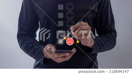 Customer Review, Young man uses smartphone mobile hand with pen touching to review and gives 1 star, Customer Review, Young man uses smartphone mobile hand with pen touching to review and gives 1 star, 118694147