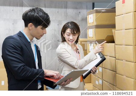 Employee checking goods in the warehouse 118694521