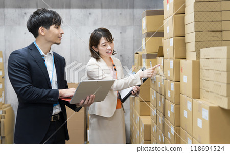 Employee checking goods in the warehouse 118694524