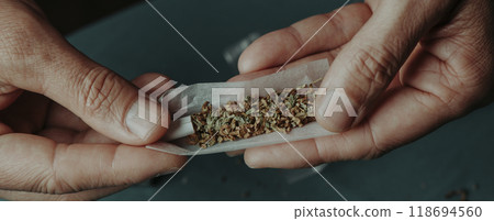 man is about to roll a joint, panoramic format man is about to roll a joint, panoramic format 118694560