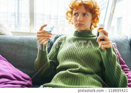 portrait of a young woman with a cold portrait of a young woman with a cold 118695421