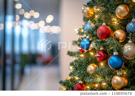 Decorated artificial Christmas tree with balls and garlands of lights in business office hallway creates festive atmosphere on eve of new year, blurred background with bokeh and copy space 118695678
