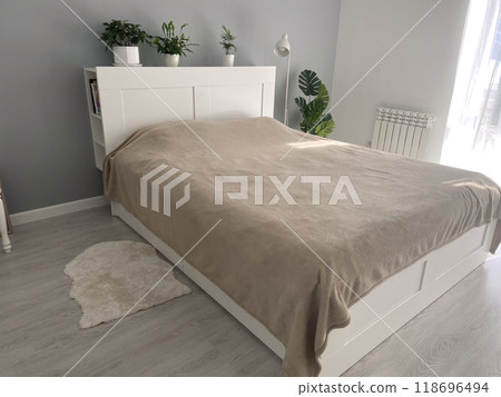 Scandinavian design bedroom with minimalist style and natural light. Home plants and simple cozy bed Scandinavian design bedroom with minimalist style and natural light. Home plants and simple cozy bed 118696494
