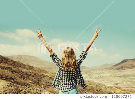 happy woman raising her hands up on hiking trail on top of mountain Tenerife, Canary Islands, Spain happy woman raising her hands up on hiking trail on top of mountain Tenerife, Canary Islands, Spain 118697275