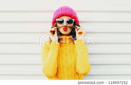 Fashion portrait funny young woman shows mustache hair blowing kiss having fun over white background 118697282