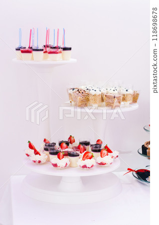 Candy bar at celebration party. Wedding table with sweets, cake, pastries, muffins, sugar treats. 118698678