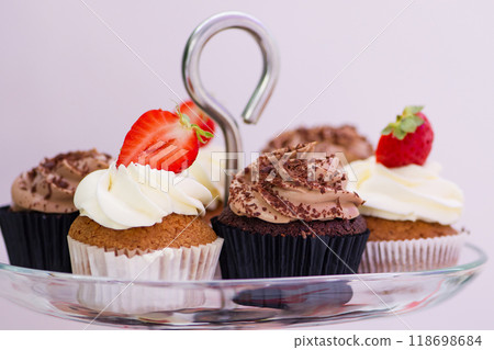 Candy bar at celebration party. Close up of sweets, cakes, pastries, muffins with strawberries. 118698684