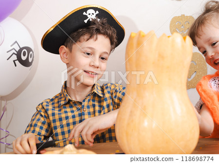 Children at Halloween workshop learning to carve pumpkins for holiday decoration Children at Halloween workshop learning to carve pumpkins for holiday decoration 118698774