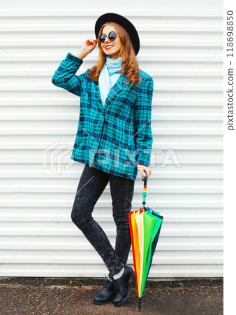 Fashion pretty young smiling woman with colorful umbrella on white background 118698850