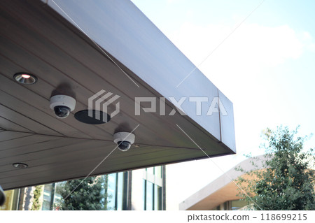 Surveillance cameras are installed under the roof overhang for enhanced safety and security Surveillance cameras are installed under the roof overhang for enhanced safety and security 118699215