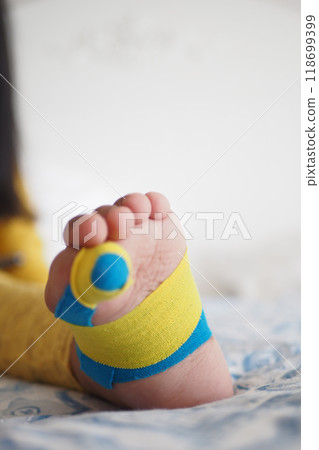 Elastic therapeutic blue tape applied to child leg. Kinesio Taping therapy for injury 118699399