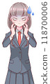 A schoolgirl in uniform with a cramp in her hands on her cheeks 118700006