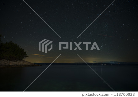 Beautiful night sky full of sparkling stars above the sea 118700028