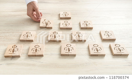 Human resources concept with a businessman arranging a series of wooden blocks 118700374