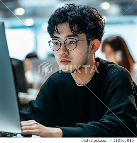 A man heading to a computer 118703010