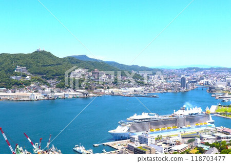Nagasaki city and a luxury cruise ship anchored at Nagasaki Port Nagasaki city and a luxury cruise ship anchored at Nagasaki Port 118703477