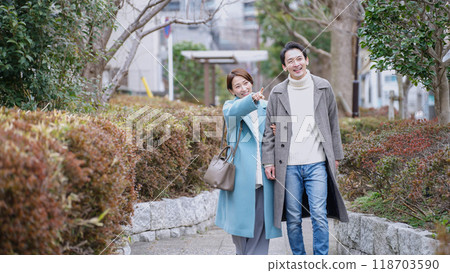 A couple on a winter park date (winter clothes, coat, jacket) A couple on a winter park date (winter clothes, coat, jacket) 118703590
