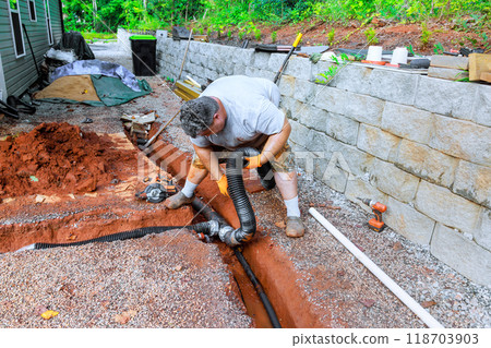 In trench underground, drainage pipes are laid assembled for outflow of rainwater stormwater 118703903