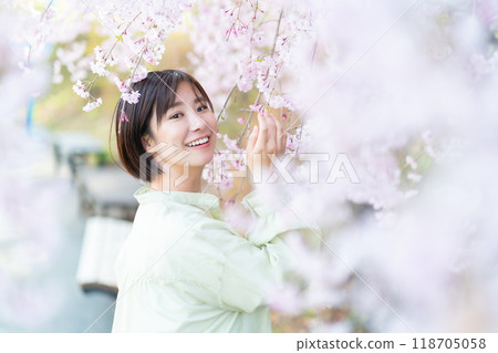 A woman touching a cherry blossom, a woman looking at cherry blossoms, a woman admiring cherry blossoms A woman touching a cherry blossom, a woman looking at cherry blossoms, a woman admiring cherry blossoms 118705058
