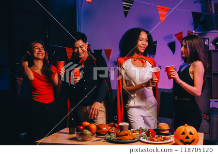 Joyful office Halloween party with coworkers in costumes, celebrating with drinks and laughter, fostering teamwork and festive spirit 118705120