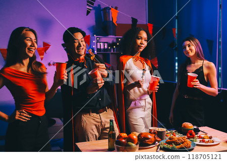 Joyful office Halloween party with coworkers in costumes, celebrating with drinks and laughter, fostering teamwork and festive spirit Joyful office Halloween party with coworkers in costumes, celebrating with drinks and laughter, fostering teamwork and festive spirit 118705121