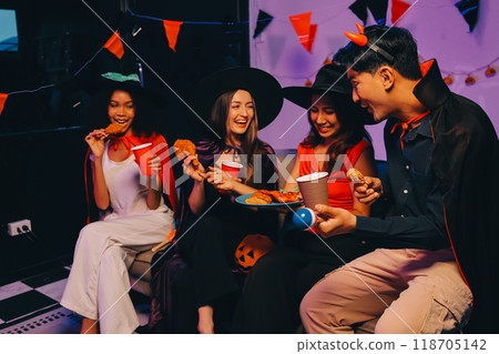 Joyful office Halloween party with coworkers in costumes, celebrating with drinks and laughter, fostering teamwork and festive spirit 118705142