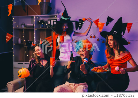 Joyful office Halloween party with coworkers in costumes, celebrating with drinks and laughter, fostering teamwork and festive spirit 118705152