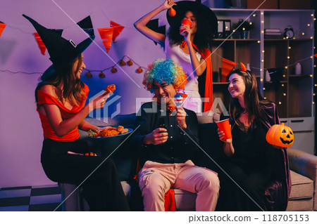 Joyful office Halloween party with coworkers in costumes, celebrating with drinks and laughter, fostering teamwork and festive spirit 118705153