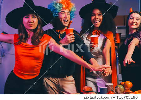Joyful office Halloween party with coworkers in costumes, celebrating with drinks and laughter, fostering teamwork and festive spirit 118705180