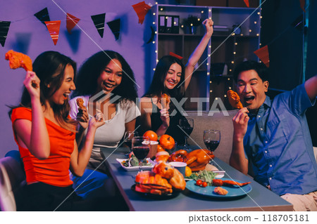 Joyful office Halloween party with coworkers in costumes, celebrating with drinks and laughter, fostering teamwork and festive spirit 118705181