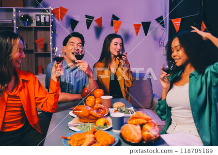 Joyful office Halloween party with coworkers in costumes, celebrating with drinks and laughter, fostering teamwork and festive spirit 118705189