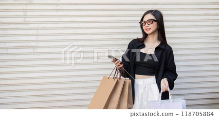 Trendy Woman Enjoys Shopping Spree on Black Friday with Multiple Bags Trendy Woman Enjoys Shopping Spree on Black Friday with Multiple Bags 118705884