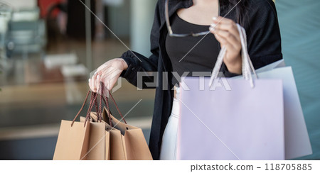 Stylish Shopper Examining Pre Black Friday Purchases in Mall 118705885